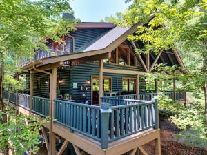 a house with a wrap around porch with a blue deck at The Holiday Cabin at Lake Lure in Lake Lure