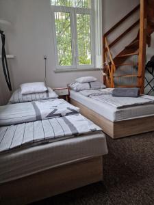 three beds sitting in a room with a window at nocleg blisko dworca Krosno in Krosno