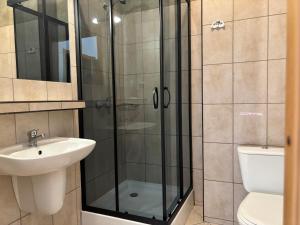 a bathroom with a shower and a sink at Ośrodek Wczasowy BOBO in Koczała +50 photos