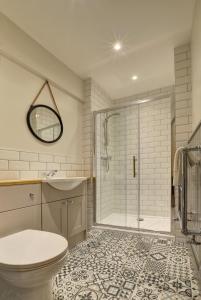 a bathroom with a shower and a toilet and a sink at Hideaway in Appledore