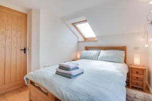 a bedroom with a bed with towels on it at The Hop House in Welcombe