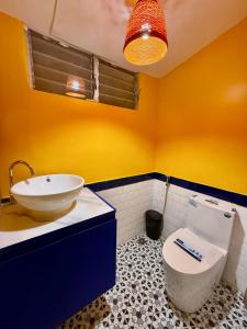 a bathroom with a sink and a toilet in it at Casa Lina-San Juan, La Union in San Juan