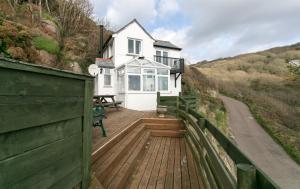 a house with a wooden deck with a fence at The Magazine in Paul