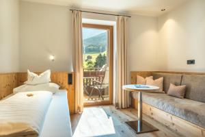 a hotel room with a bed and a couch at Parc Hotel Tyrol in Castelrotto +73 photos