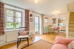 a living room with a chair and a table at Tump Cottage in Walford