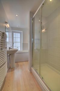 a bathroom with a glass shower and a sink at Lobsters Loft in Appledore +19 photos