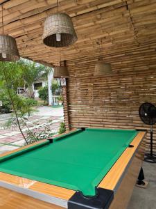 a pool table in a room with a wall at African Treasure Beach Resort in Kokrobite