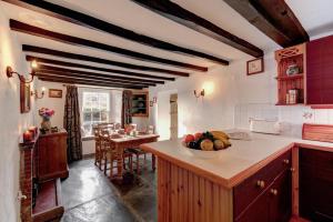 a kitchen with a bowl of fruit on a counter at Rose Cottage in Chapel Stile