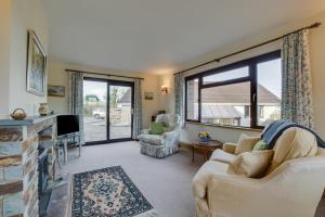 a living room with a couch and a fireplace at Gwels Efan Barn in Saint Issey