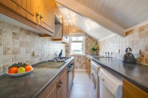 a kitchen with a bowl of fruit on the counter at West Pier Flats in St Ives