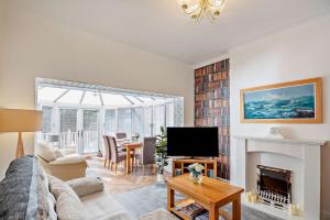 a living room with a couch and a fireplace at North Bay Bungalow in Rhôs-on-Sea