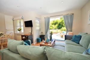 a living room with a couch and a table at Heylyn in Little Petherick