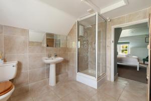 a bathroom with a shower and a sink and a toilet at Kelwon Cottage in Saint Brides +20 photos