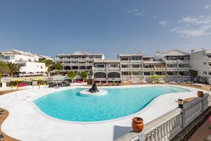 an image of a swimming pool at a resort at The Colors House, 513 nice and cosy in Costa Teguise