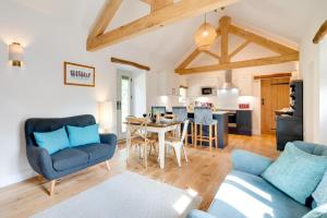 a living room with two blue chairs and a table at 2 Bed in Danby oc-wa315 in Castleton
