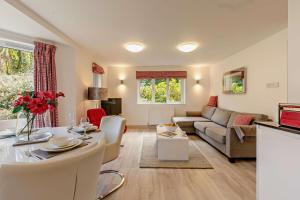 a living room with a couch and a table at Sennen - St Ives in Carbis Bay