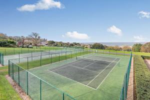 a tennis court with two tennis courts at Sennen - St Ives in Carbis Bay