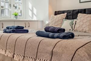 two pillows sitting on top of a bed at Pearl Cottage - St Agnes in St. Agnes  +4 photos
