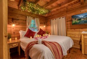 a bedroom with a bed in a log cabin at Buzzard Roost cabin at Cabin Fever in NC in Saluda +31 photos