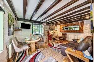 a living room with a couch and a table at Cascades Cottage in Blaenau-Ffestiniog