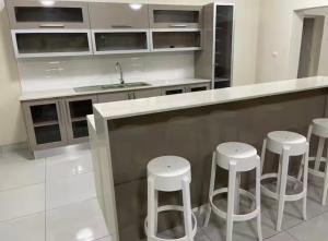 a kitchen with a counter with stools in it at Wildlife Oasis in Marloth Park +14 photos