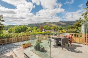 a patio with a table and chairs and a fence at Undergarth Cottage in Chapel Stile