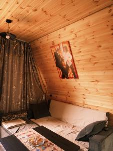 a bedroom with a bed in a wooden cabin at NitsHouse! in Tsemi