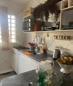 a kitchen with a counter with a bowl of fruit at Orla de Macapá in Macapá