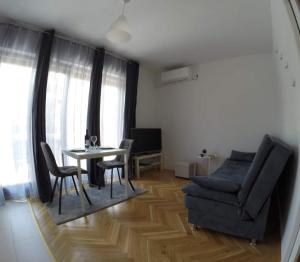 a living room with a couch and a table at Apartment Jacky in Rovinj +7 photos