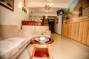 a living room with a couch and a table at Hotel Greenwich in Kigali