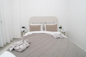 a bedroom with a white bed with towels on it at LUXURY Apartment - IPTV - AC - Easy Parking - Cosy stay in Tangier