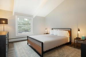 Un dormitorio blanco con una cama y una ventana. en 120 Gopher Rd #B14, en Avon