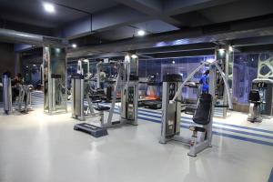 a gym with a bunch of treadmills and machines at Guest House Suites in Bangalore