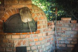 a brick oven with two mitts in front of it at Bell House in Bükkzsérc
