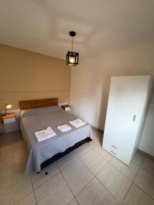 a bedroom with a bed and a white cabinet at Complejo Sucre I in San Luis