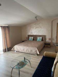 a bedroom with a bed and a glass table at Къща за гости Алекс in Sinemorets
