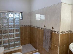 a bathroom with a shower and a toilet and a sink at Estancia Calafia in Los Pozos +9 photos