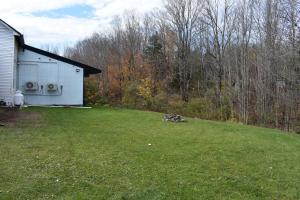 a yard with a white house and a field of grass at Tannersville Village Room 1 in Tannersville