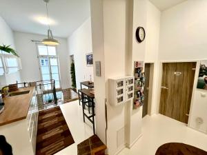 a kitchen and living room with a clock on the wall at Adlzreiter City Pension in Munich