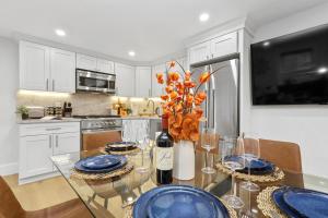 a kitchen with a table with blue plates and a bottle of wine at North End Entire House in Boston