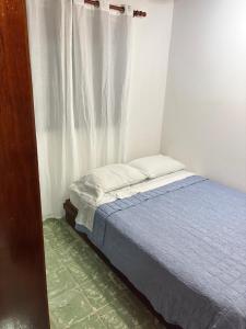 a small bed in a room with a window at Majagual Beach House in Veracruz +17 photos