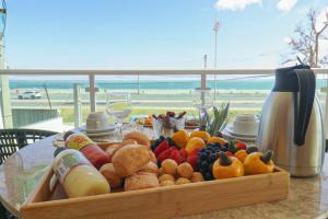 a table with a tray of fruits and vegetables on it at Maren Praia Hotel in São Luís