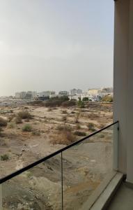 a balcony with a view of a city at Muscat City Stay-2BR Apt 108 near Grand & Avenue Mall in Ghubrah +8 photos