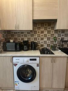 a kitchen with a washing machine on a counter at Bella in Tbilisi City
