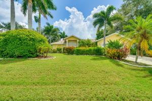 a house with palm trees and a yard at Near Sun Splash Waterpark Coral Princess Oasis in Cape Coral