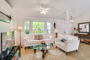 a living room with white furniture and a ceiling fan at Near Sun Splash Waterpark Coral Princess Oasis in Cape Coral