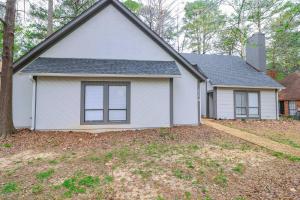 a white house with a tree in a yard at Reservoir Modern 3BR Home in Brandon