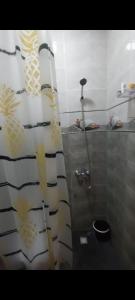 a bathroom with a shower and a toilet in a room at Nour Alkindi Nador in Nador