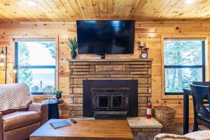 a living room with a fireplace and a flat screen tv at Adventure & Relaxation by Lake Superior in Paradise +12 photos