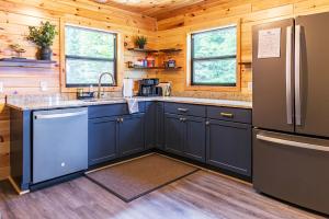 a kitchen with blue cabinets and a refrigerator at Adventure & Relaxation by Lake Superior in Paradise